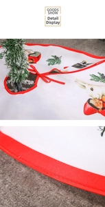 Detail of white Christmas tree skirt with cute rabbit print and red bow tie-on closure