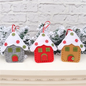 Detailed close-up of three felt Christmas house ornaments with festive embroidery