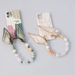Stylish wavy marble phone case with beaded wrist strap and silk scarf ribbon accessory
