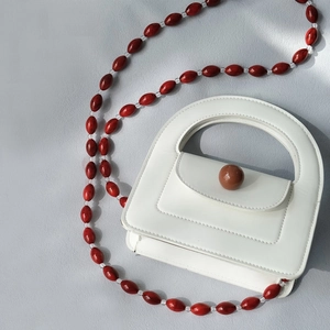 White PU leather mini handbag with long amber and transparent bead chain strap