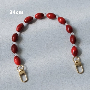 Detailed 34cm red acrylic bead bag chain accessory with golden spring clasps