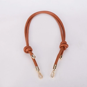 Detail view of brown leather bag strap with polished gold metal hooks for DIY handbags