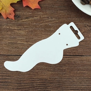 Foot-shaped white cardboard jewelry display card for anklets on a rustic wooden background