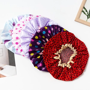 Detail of colorful polka dot waterproof shower caps with elastic ruffled edges