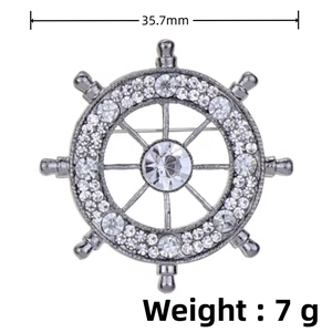 Detail view of silver ship wheel brooch showing 35.7mm diameter and 7g weight measurements