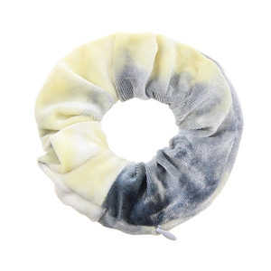 Detail view of tie-dye velvet scrunchie with hidden white zipper pocket functional design