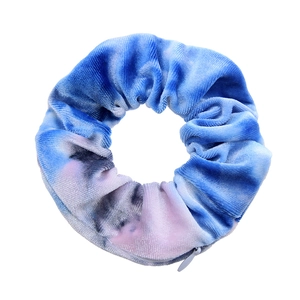 Detail shot of tie-dye velvet hair scrunchie featuring a hidden zipper pocket for storage
