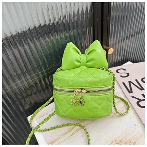 Detailed close-up of quilted pattern and gold floral zipper on lime green bow bag
