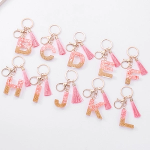 Pink resin alphabet keychains with gold foil and matching tassels for handbags