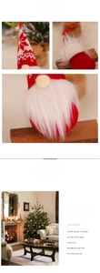 Detail view of red knitted Christmas gnome hanging ornament with snowflake patterns
