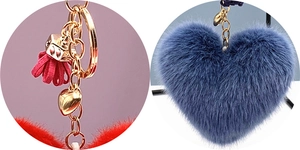 Close-up of fluffy heart keychain with gold hardware and tassel in blue and red