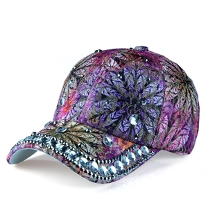 Detailed close-up of luxury floral baseball cap with colorful print and sparkling rhinestones