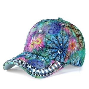 Detailed view of large rhinestones and colorful floral print on the baseball cap side