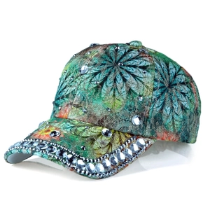 Detailed macro view of crystal rhinestones on printed floral baseball cap with metal rivets
