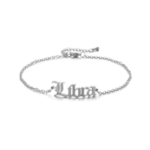 Macro shot of silver Libra constellation anklet with Gothic lettering and extender chain