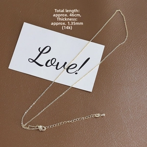 Detailed view of 14k gold-plated 1.35mm adjustable chain with lobster clasp and 46cm length