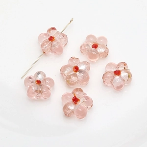 Detailed view of six pink glass flower beads for DIY jewelry with gold metal pin
