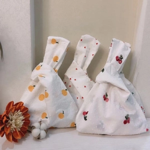 Japanese knot wrist bag with fruit heart patterns on white 3D polka dot fabric