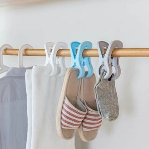 Large windproof plastic clothes clips in white and blue hanging on a wooden rod
