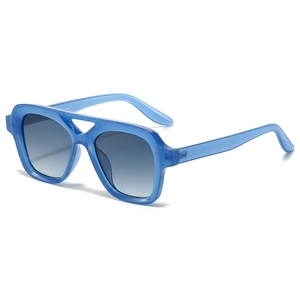 Modern square double bridge sunglasses with translucent blue frame and gradient lenses