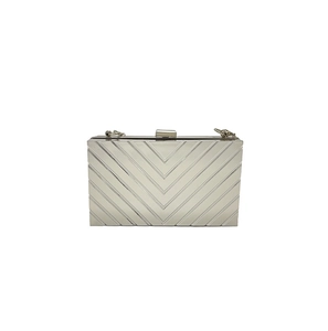 Detailed view of silver chevron texture on a rectangular metallic evening clutch bag