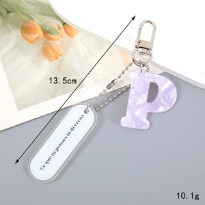 Macro detail of purple marble acrylic letter P keychain with silver clasp and small tag