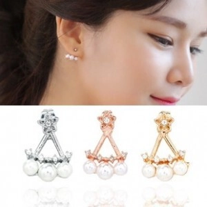 Detailed view of floral pearl stud earrings in silver, rose gold, and gold on model