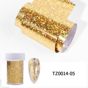 Detail of holographic gold nail foil roll and bottle for DIY artistic manicures