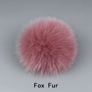 Detailed close-up of fluffy pink fox fur pompom showing soft texture and premium quality