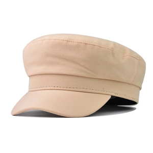 Detail showing the fine stitching and khaki cotton texture of the classic baker boy hat
