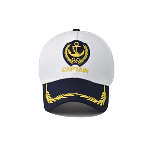 White nautical captain baseball cap with gold anchor embroidery and navy blue brim visor