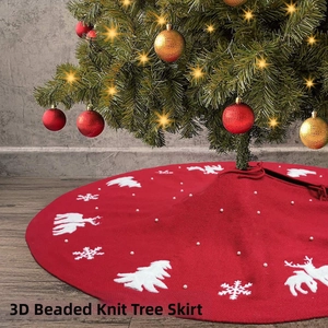 Detail of red knitted Christmas tree skirt featuring 3D bead accents and reindeer patterns
