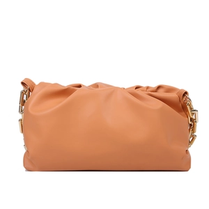 Detailed view of the tan cloud bag featuring soft pleated texture and gold metal chain strap