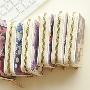 Side view of five cartoon animal print wallets with golden zippers and beige trim