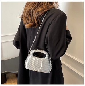 Detail of silver metallic textured crossbody bag with horizontal pleated design and chain