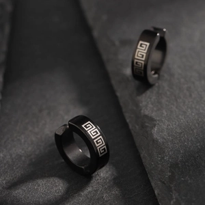 Black non-piercing titanium steel ear clips featuring classic silver meander patterns