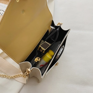 Chic beige crossbody bag with wide shoulder strap and yellow interior compartments