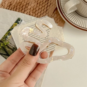 Elegant white pearlescent acetate hair claw clip in a wavy design for a stylish updo