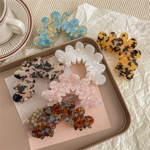 Exquisite wavy acetate hair claws in diverse patterns and floral colors for women