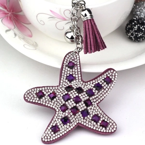 Close-up of purple starfish keychain with sparkling rhinestones and matching tassel