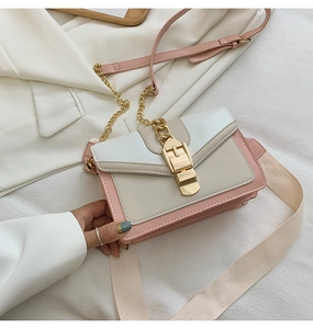 Macro detail of tricolor crossbody bag with gold hardware and wide shoulder strap