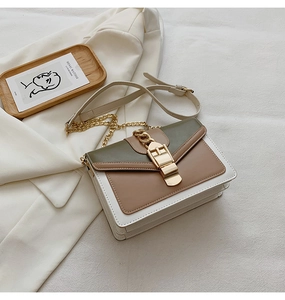 Detail of color-block PU leather crossbody bag with gold chain strap and metal buckle