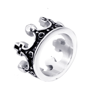 Detailed close-up of a silver crown ring with intricate patterns and black gemstone inlay