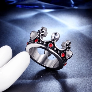 Macro shot of a vintage crown ring with red gems and black antique finish details