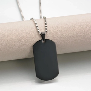 Close-up of a sleek black rectangular military tag necklace with silver box chain