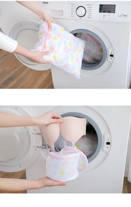 Detailed view of placing cartoon mesh laundry bags for bras and clothes in the washing machine