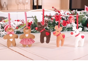 Detail of felt gingerbread and reindeer ornaments with handcrafted stitching for Christmas
