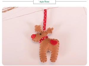 Close-up of handmade felt reindeer ornament with white stitching and red heart detail