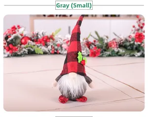 Close-up of small Christmas gnome doll with red plaid hat and grey plush body