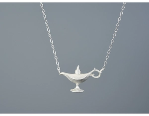 Macro detail of Aladdin magic lamp pendant with matte silver finish on a fine chain